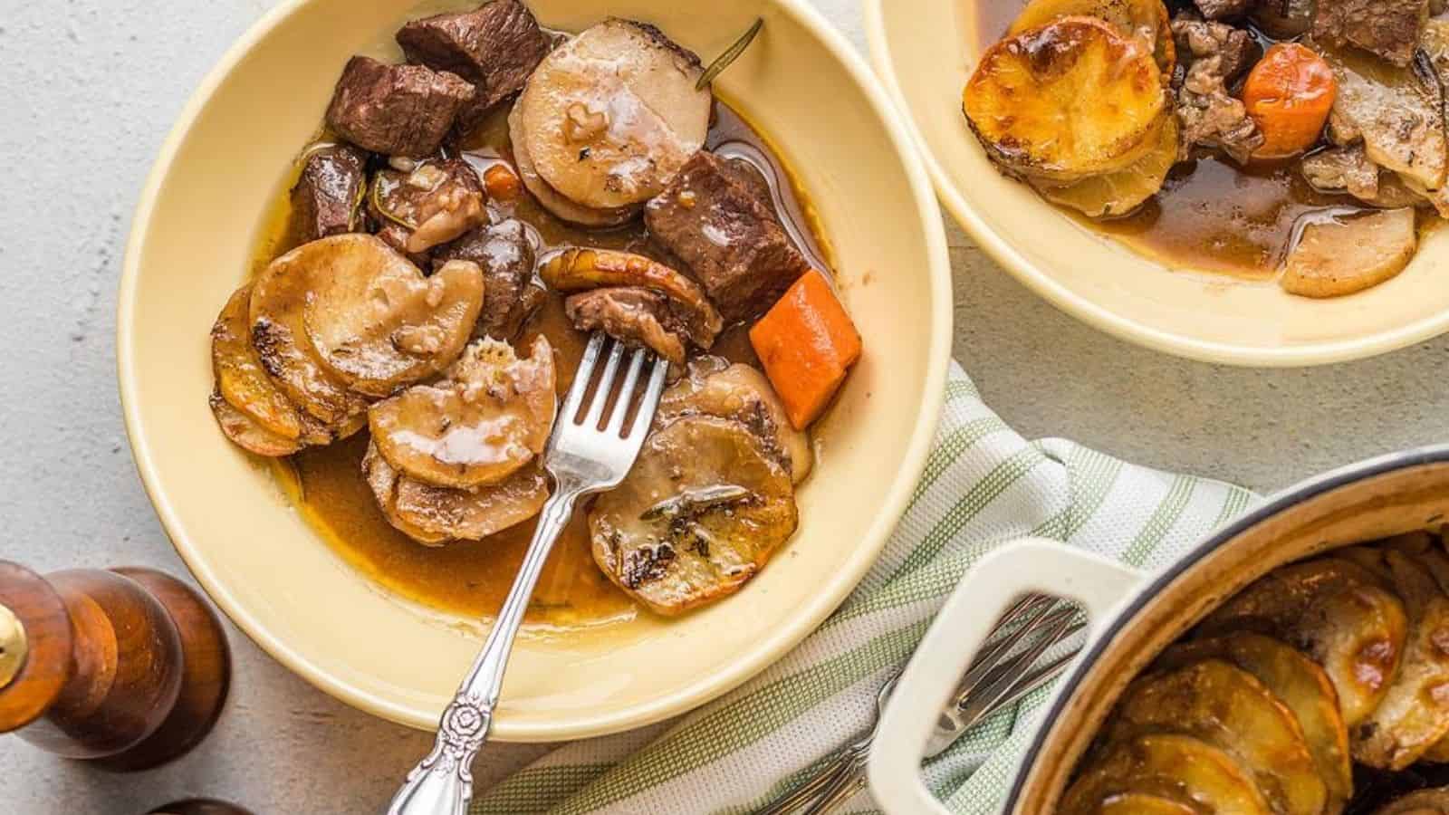 Beef and potato bake wth a fork in a plate.