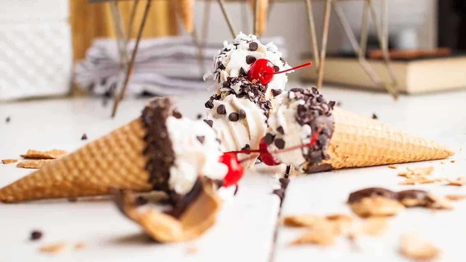 An image of four cannoli cones with cherries on top.