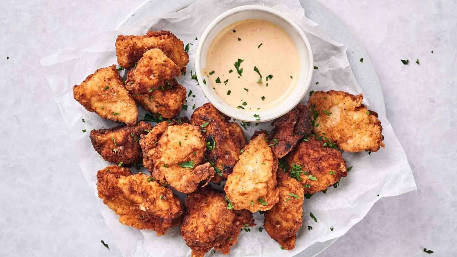 Top view of chick-fil-a chicken nuggets on a plate with a dip.