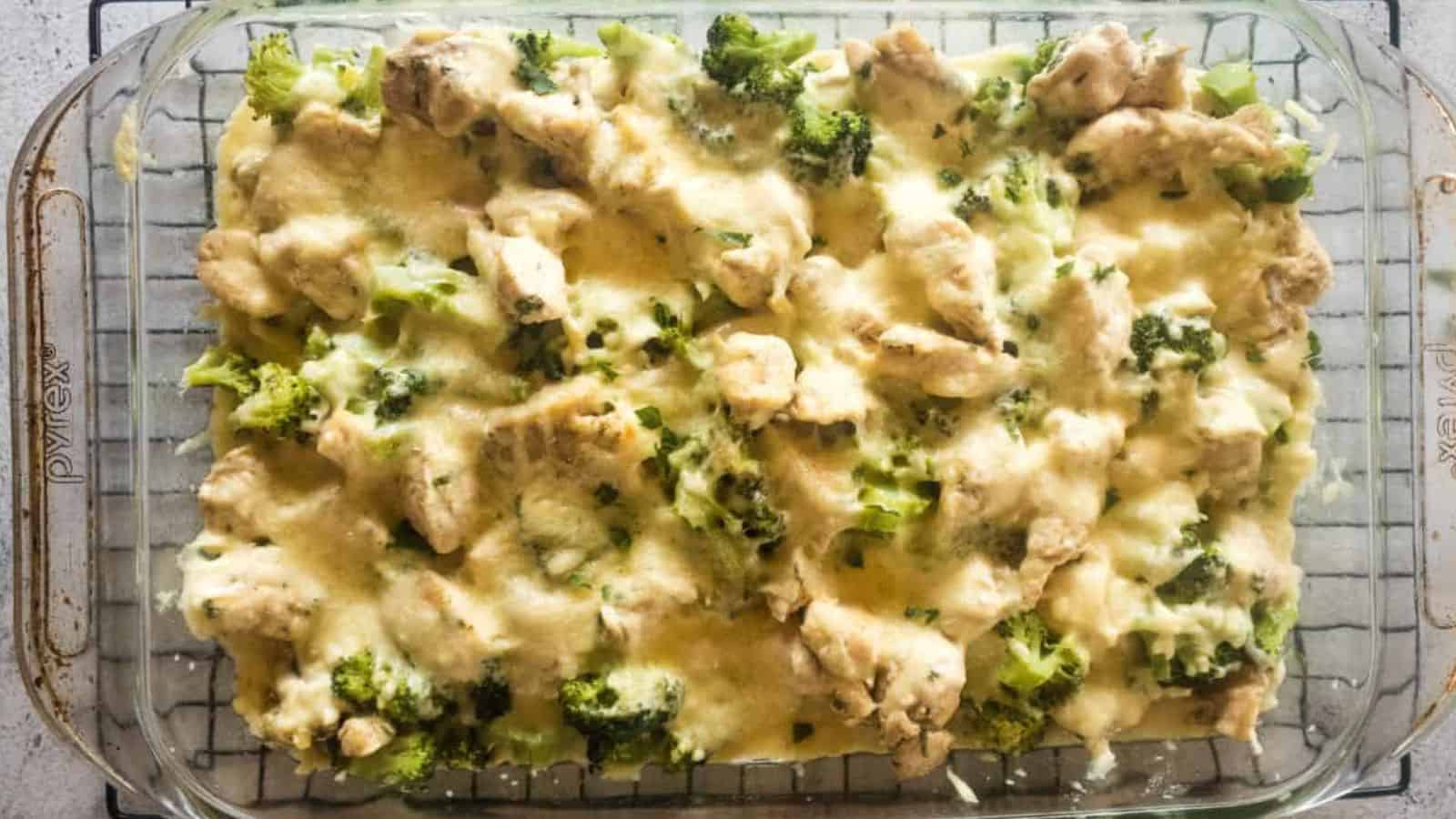 Chicken alfredo broccoli bake cooking in dish on rack.