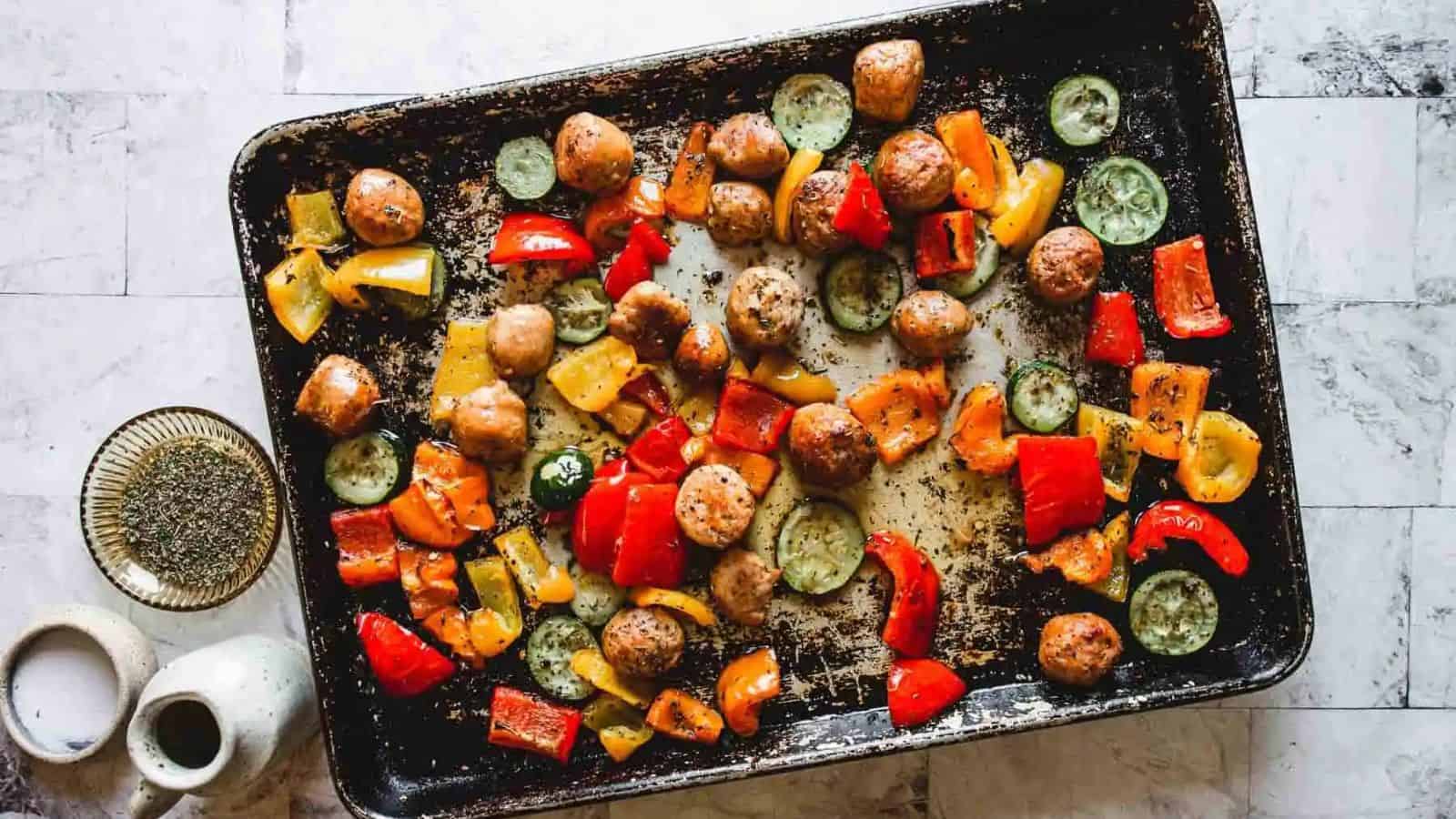 Chicken sausage and veggies on a sheet pan.