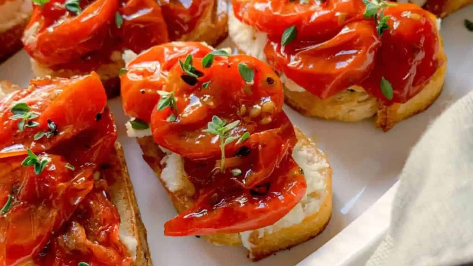 Roasted tomatoes atop toasted bread rounds with feta cheese.