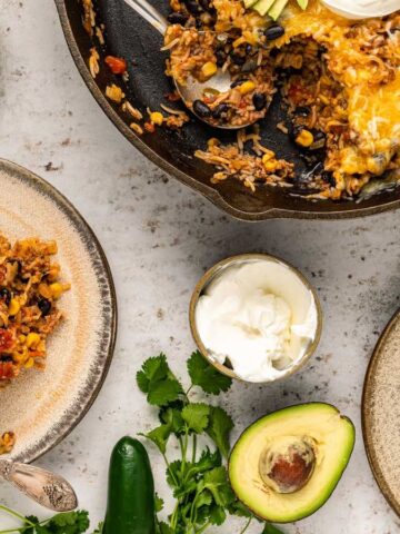 Two plates of cowboy beef and rice casserole skillet.