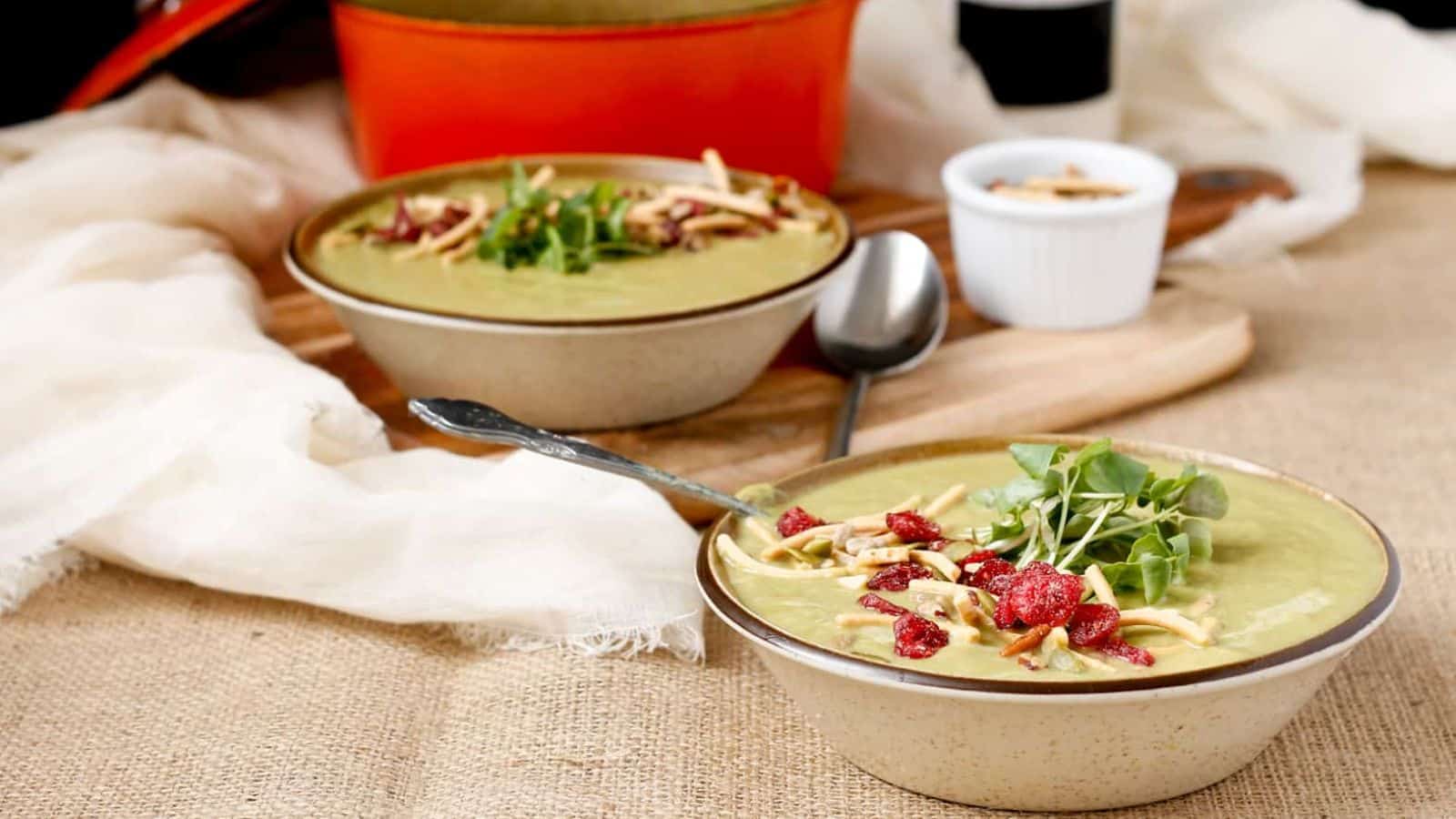 Bowls of Creamy Broccoli Stems Soup with Salad Topper Crunch.