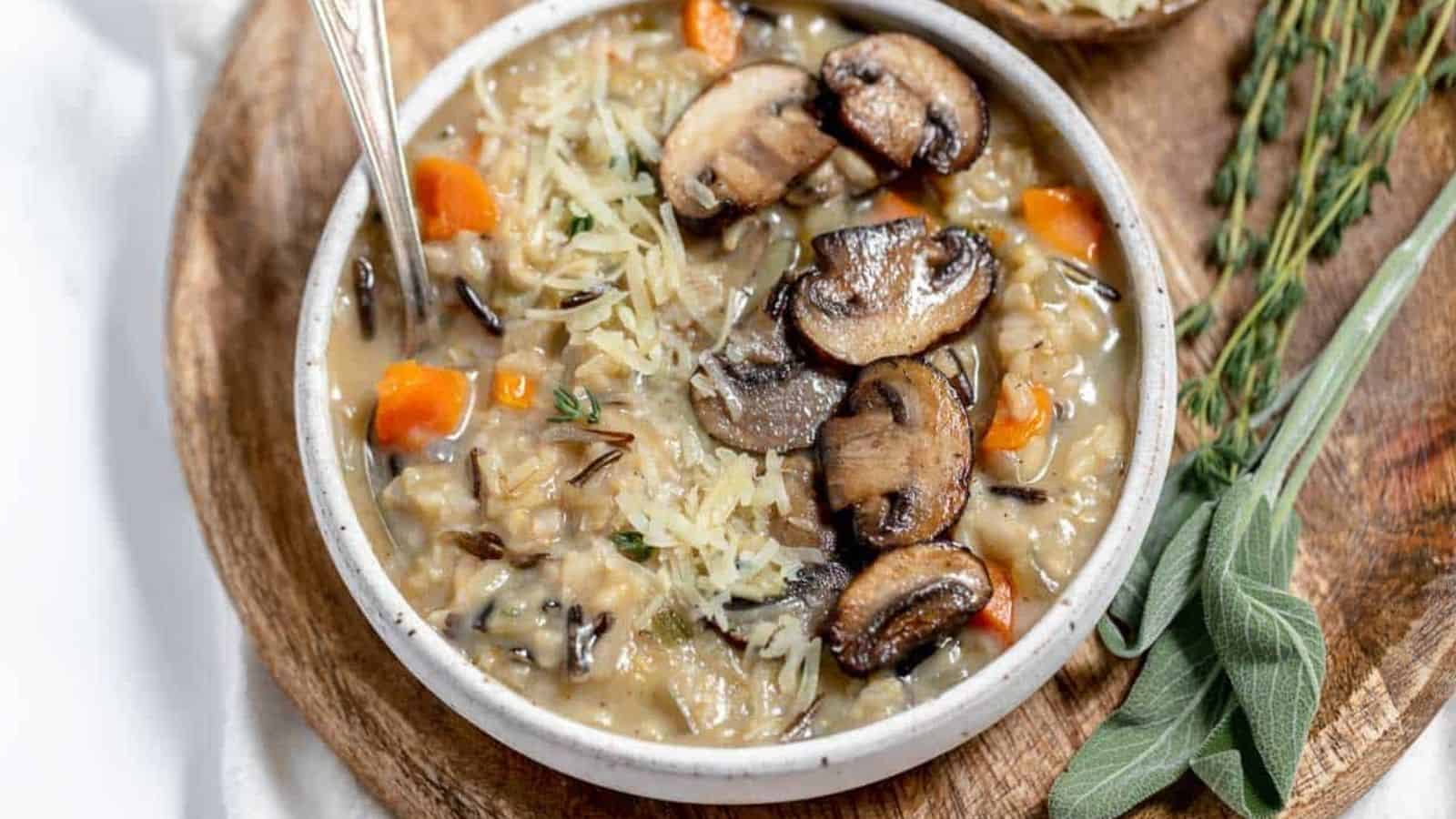 Wild rice and mushroom soup in a white bowl with sprigs of sage.