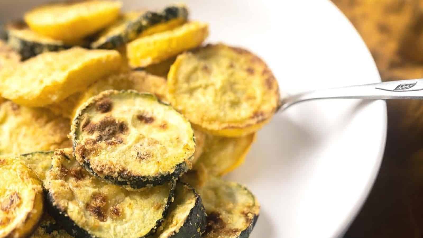Close-up of easy air fryer squash on a white plate with a spoon.