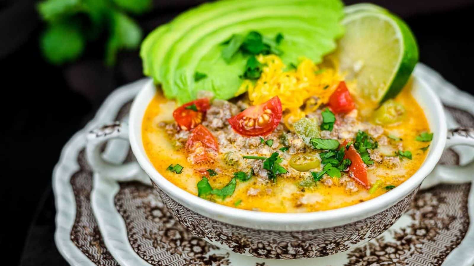 Creamy Keto Taco Soup with gresh avocado slices and lime.