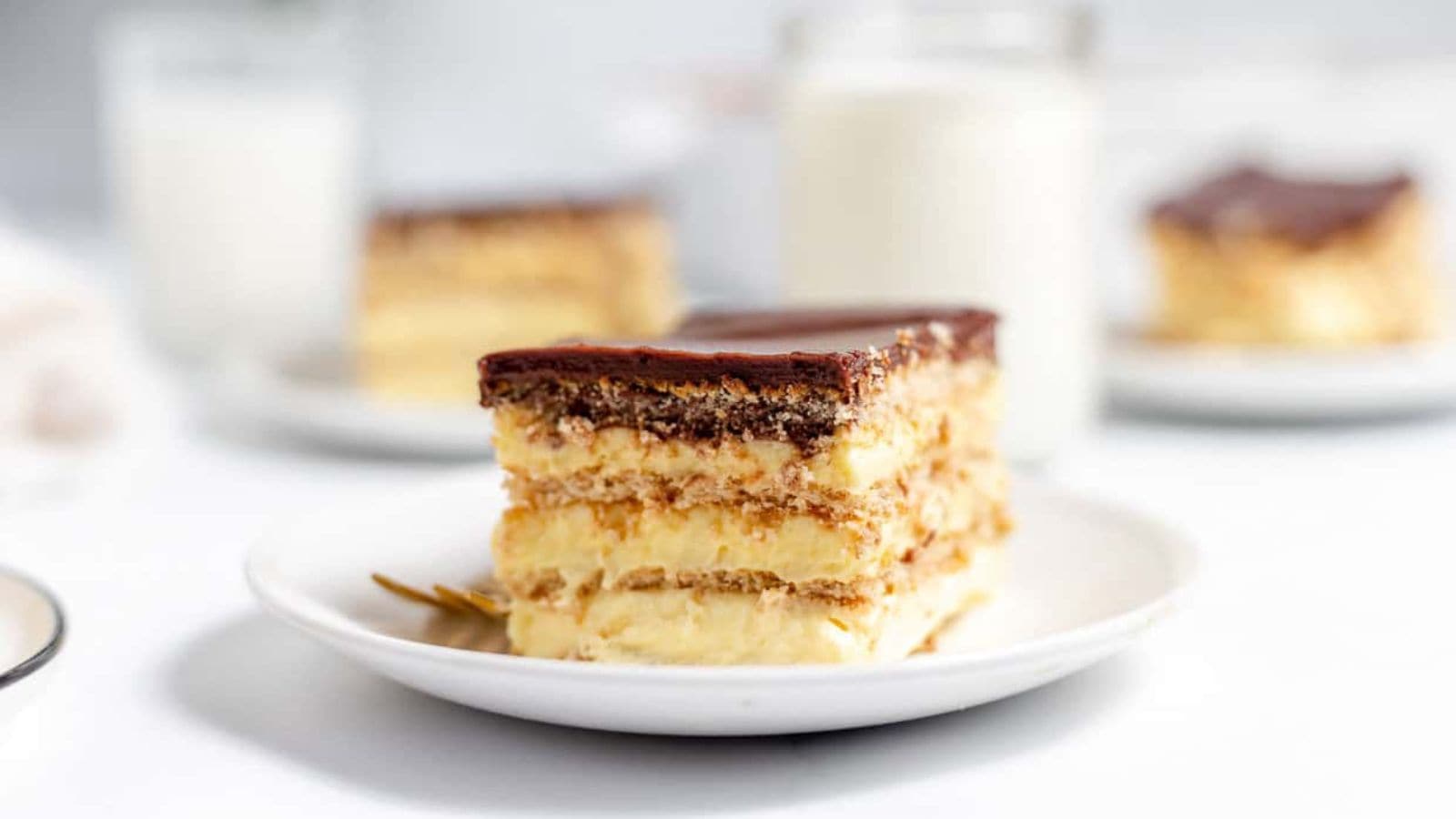 A slice of Éclair Cake on a white plate.