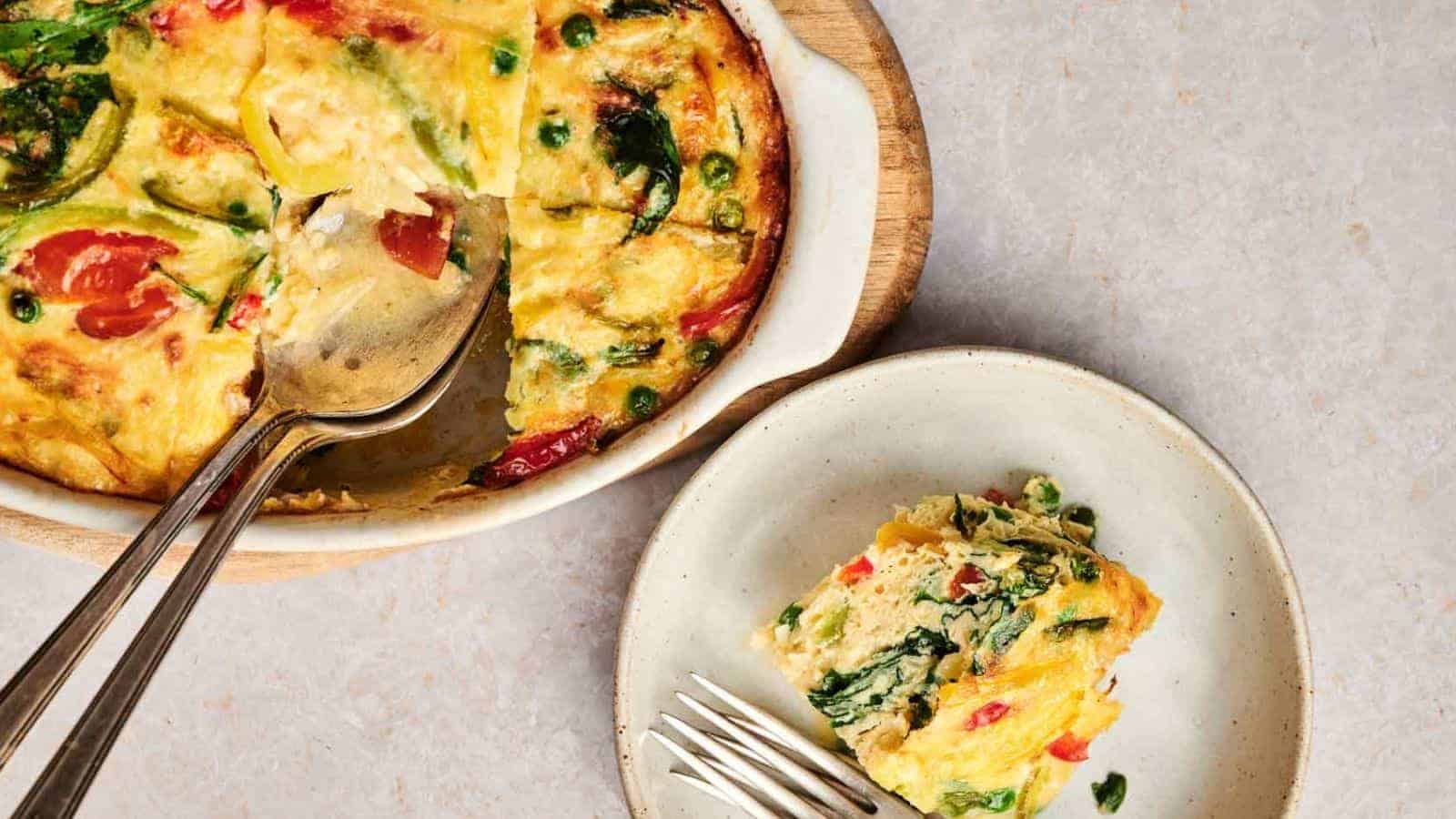 A plate with a slice of Egg & Potato Breakfast Casserole and a fork.