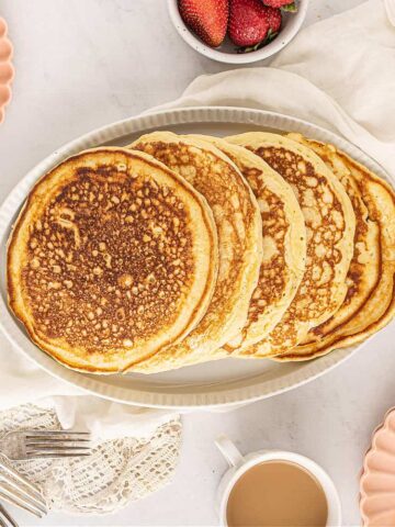 Fluffiest homemade buttermilk pancakes on a plate with syrup.