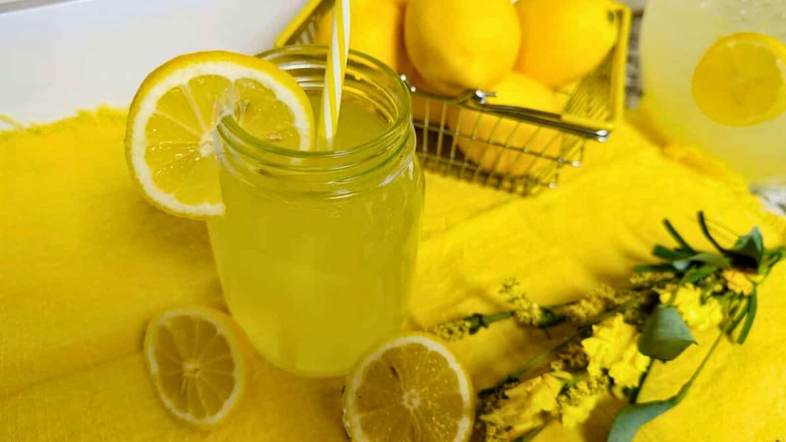 Fresh squeezed lemonade with straw in mason jar.