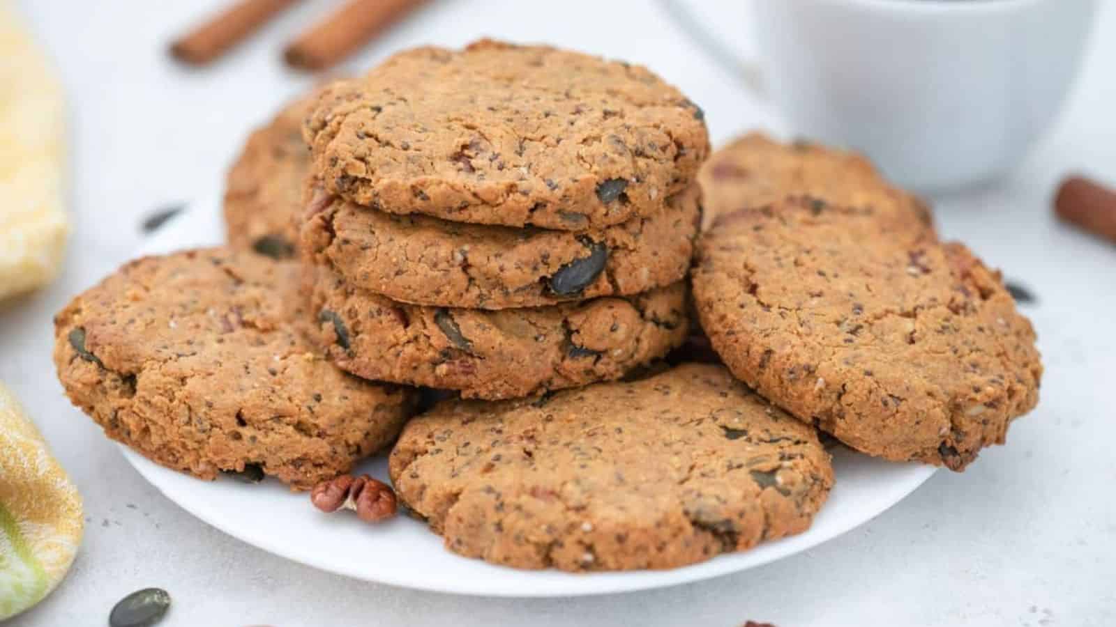 Seed and nut butter cookies on plate served with coffee.