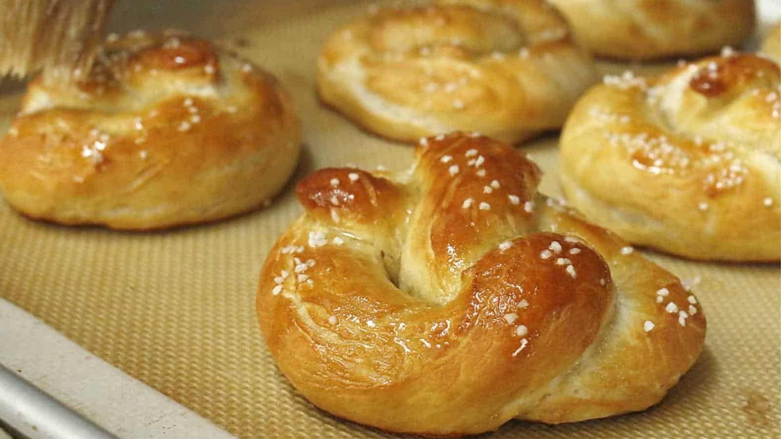 Baked pretzels on a baking sheet.