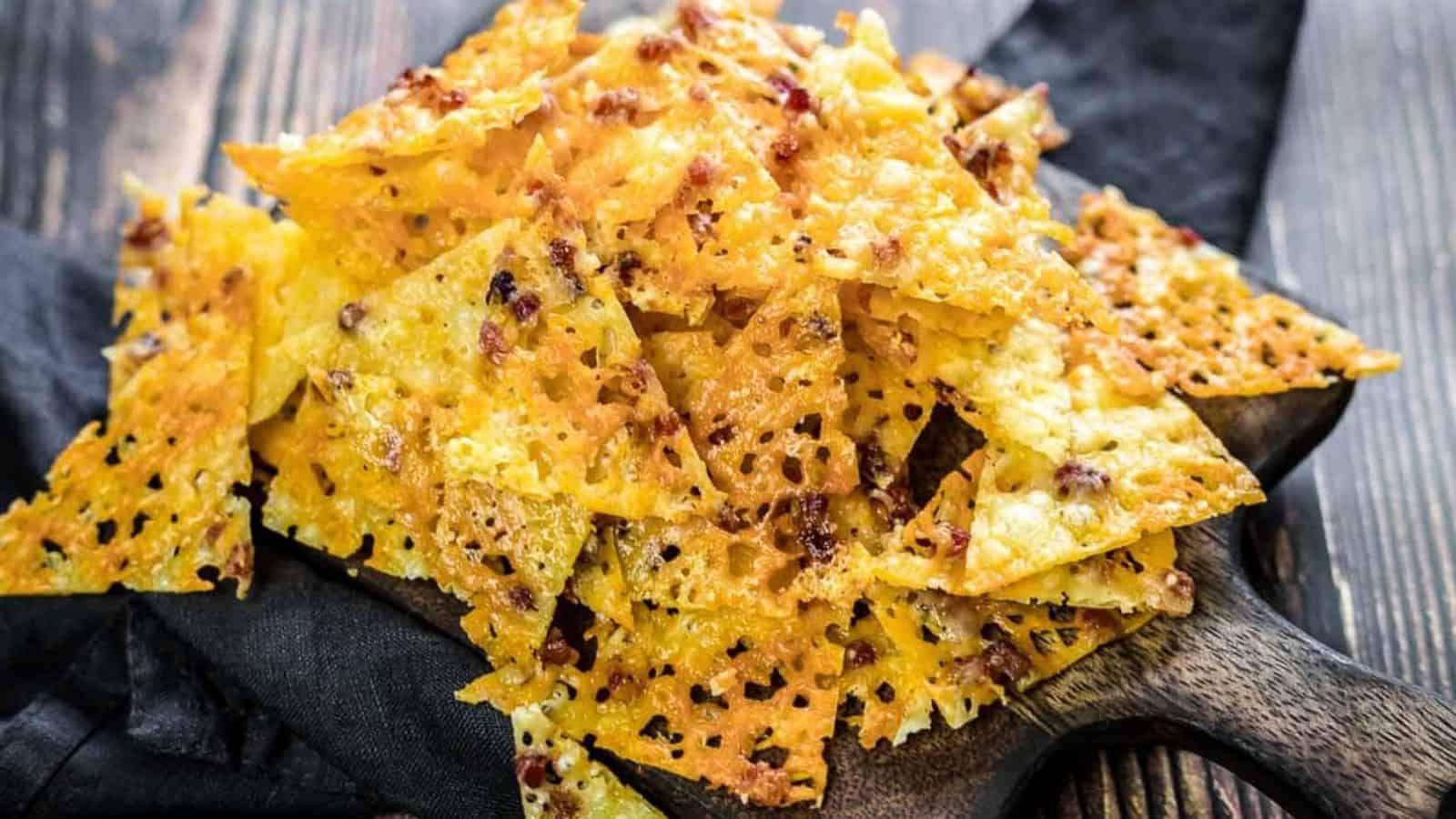 Keto Cheese Bacon Nachos Chips on a dark napkin.