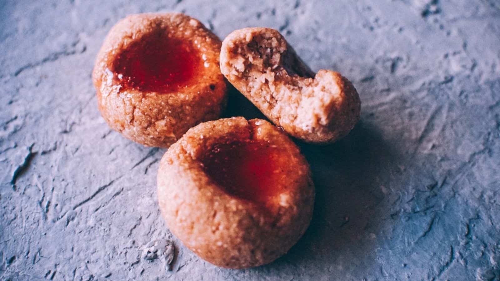 A close-up photo of three honey thumbprint cookies.