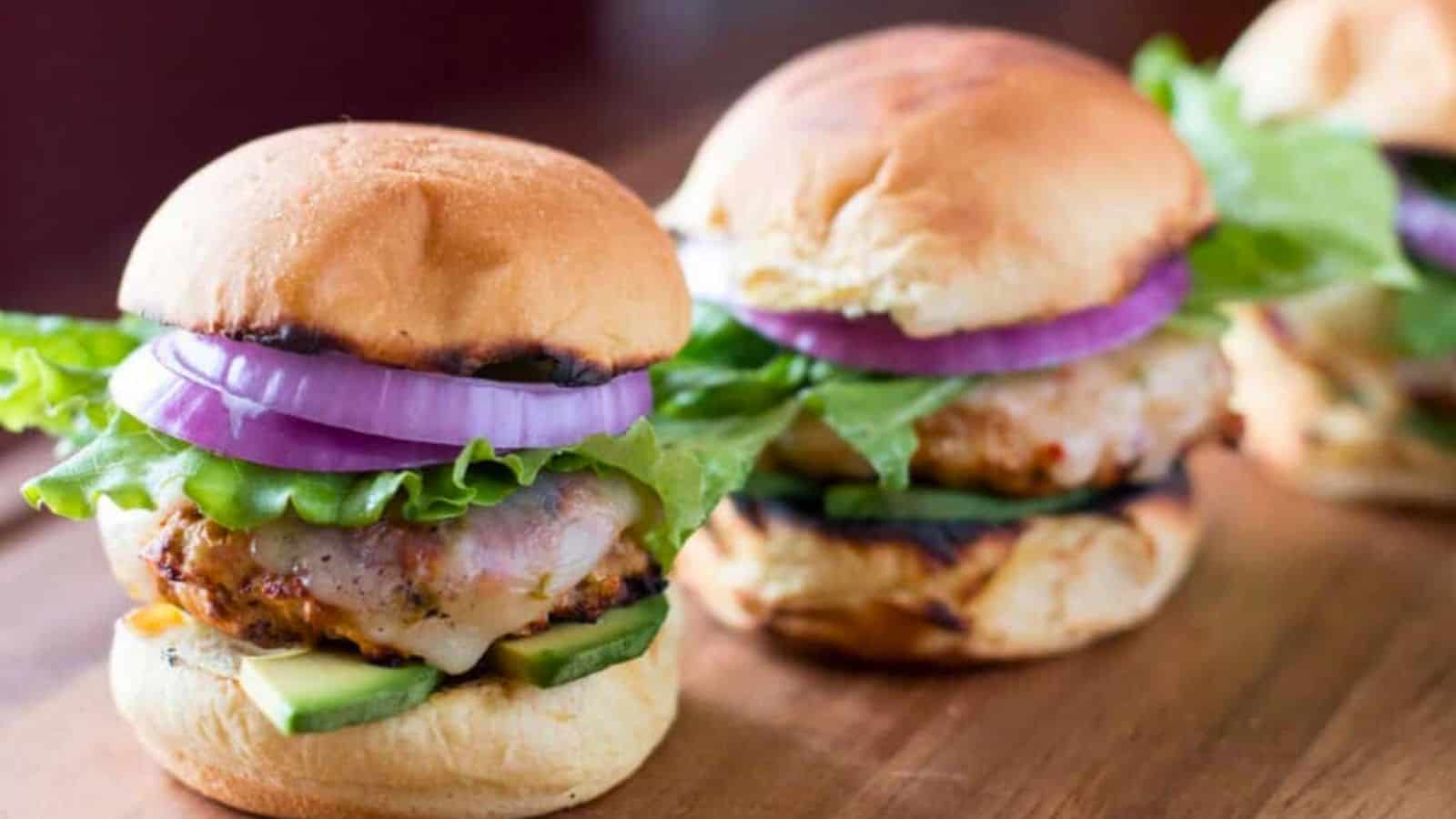 Turkey Sliders with cheese, red onion, avocado, and lettuce.