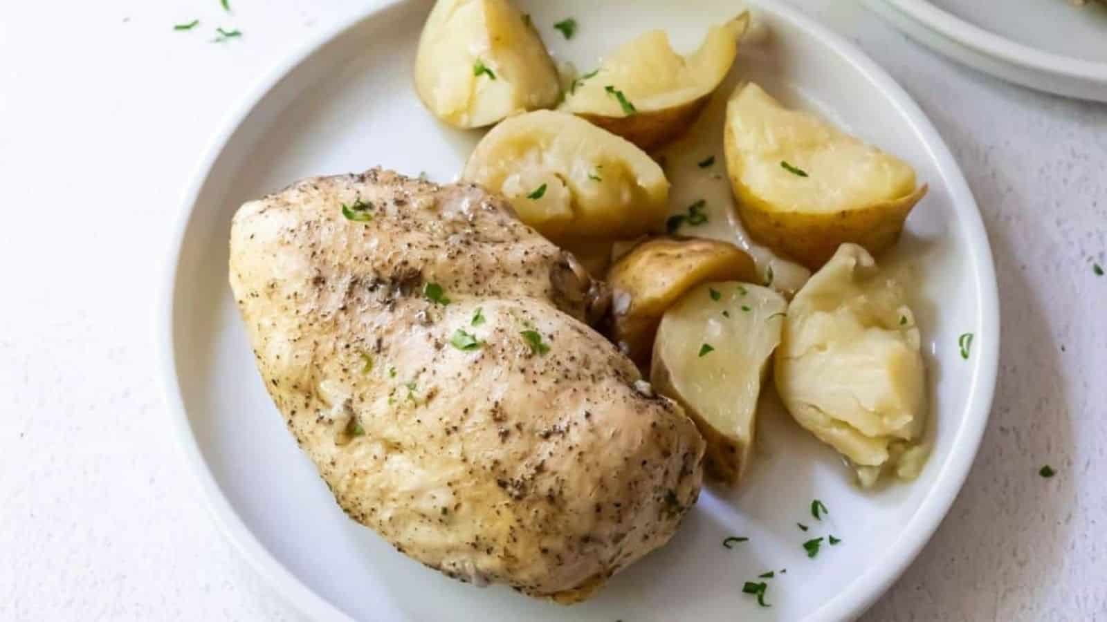 Instant Pot Chicken and potatoes with parsley on a white plate.