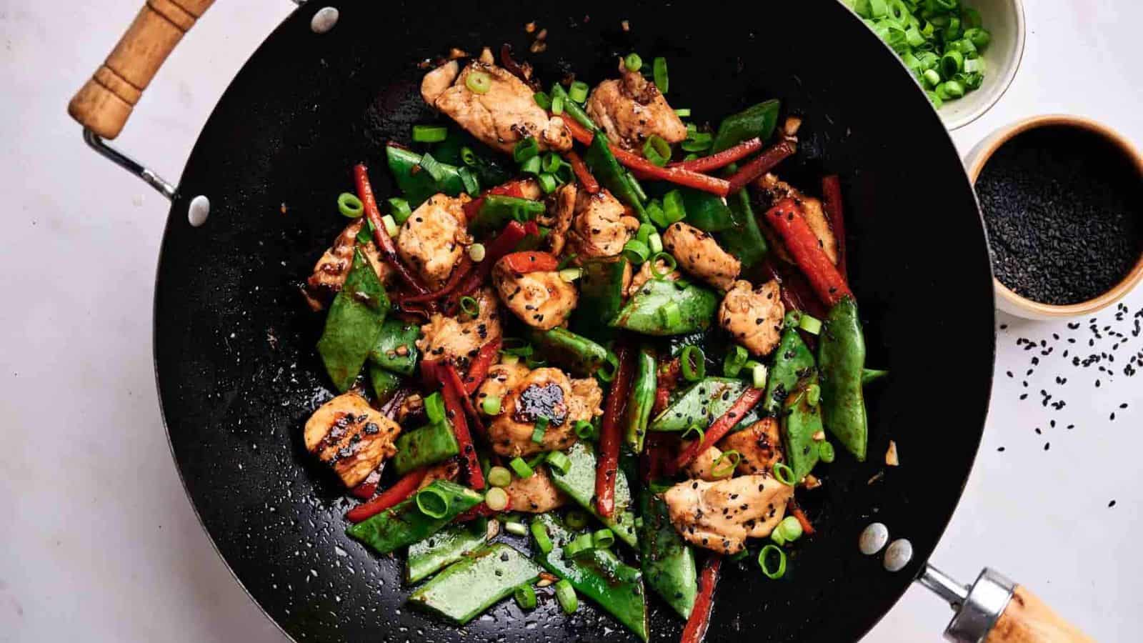 An image of kung pao chicken on a wok.