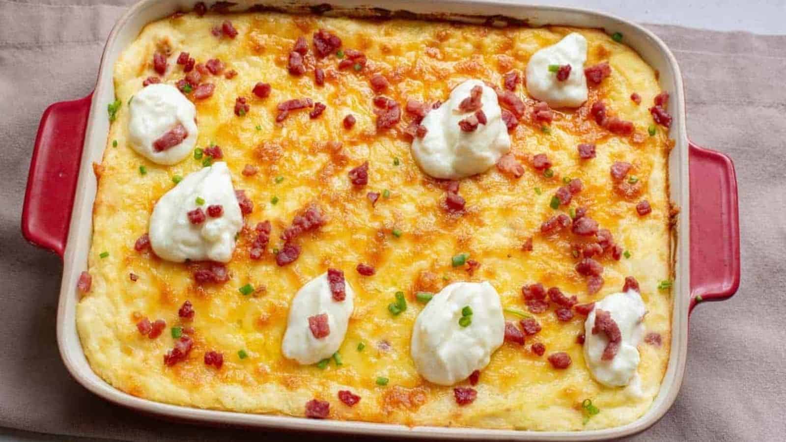 Potato casserole with bacon, cheese, and sour cream on top.
