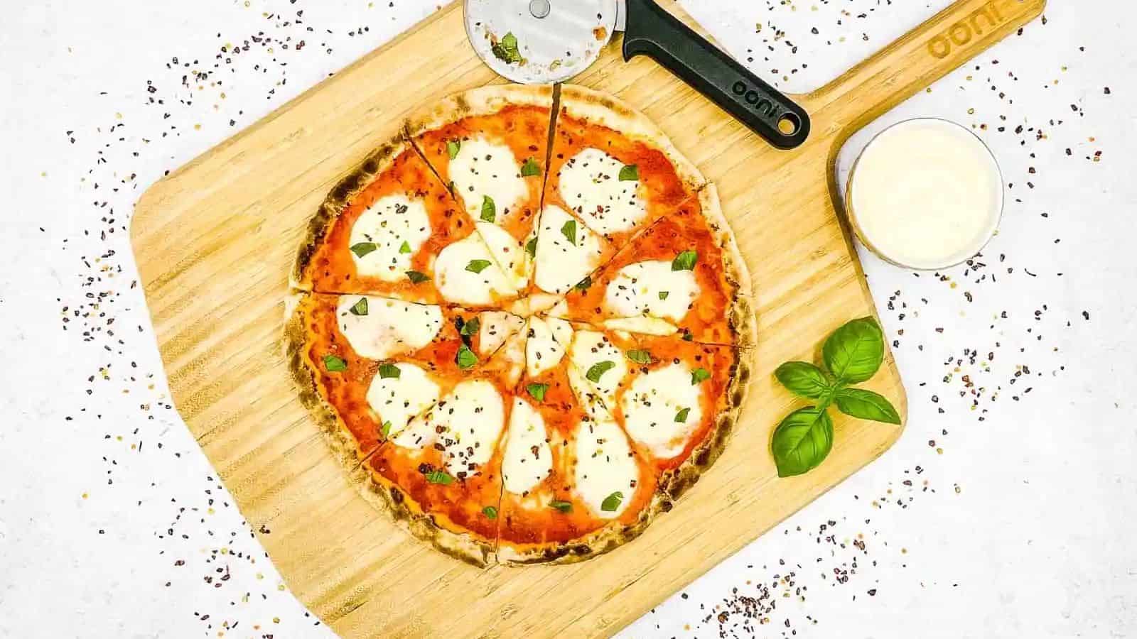 A homemade margherita pizza on a wooden board.