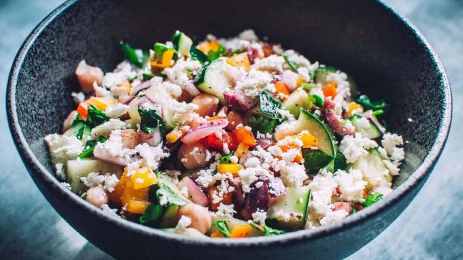 Mediterranean cucumber salad in a blac bowl.