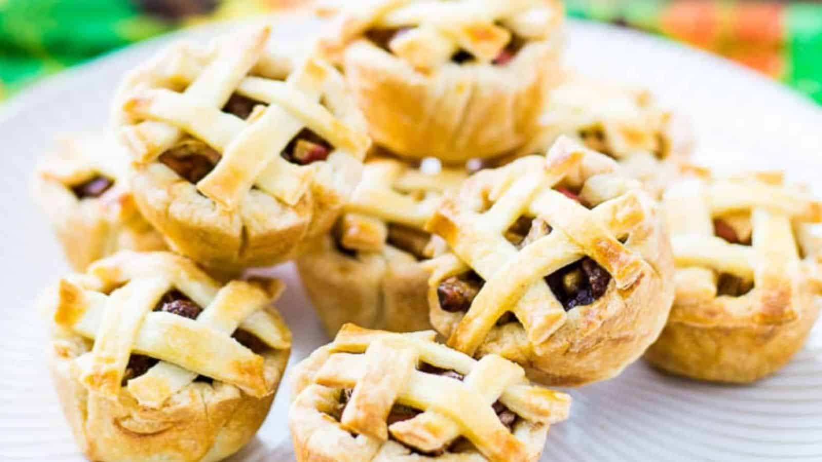 Close-up of stacks of mini apple pie in a white plate.