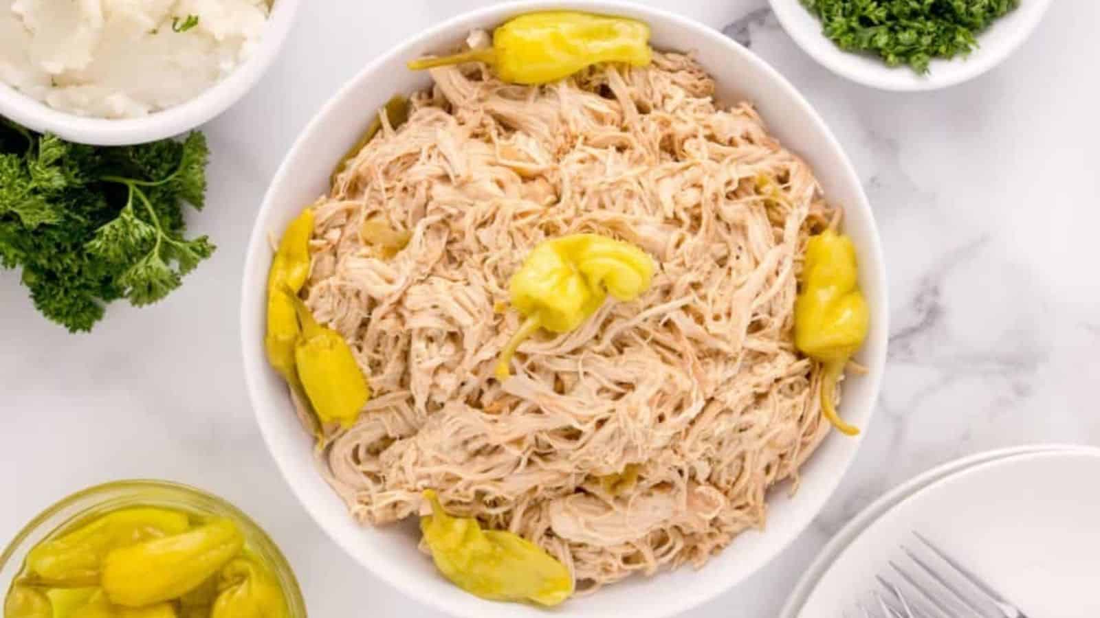 Overhead image of mississippi crockpot chicken in a white bowl.