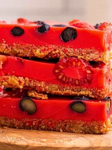 Stack of mixed berry jello on a wooden board.