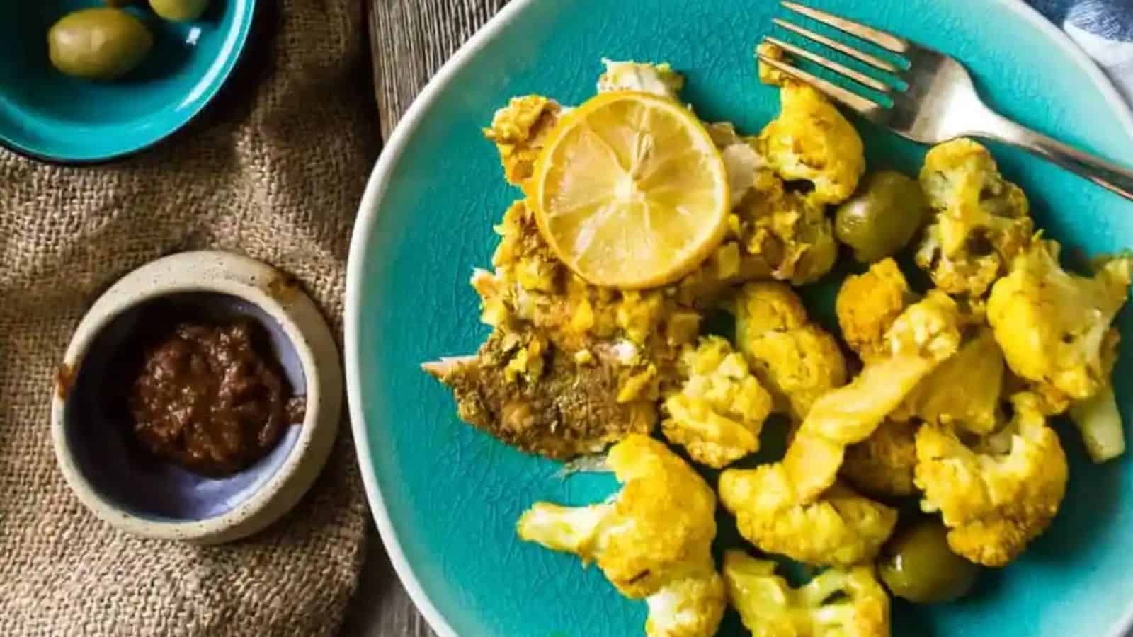 Overhead image of moroccan salmon sheet pan dinner in a blue plate.