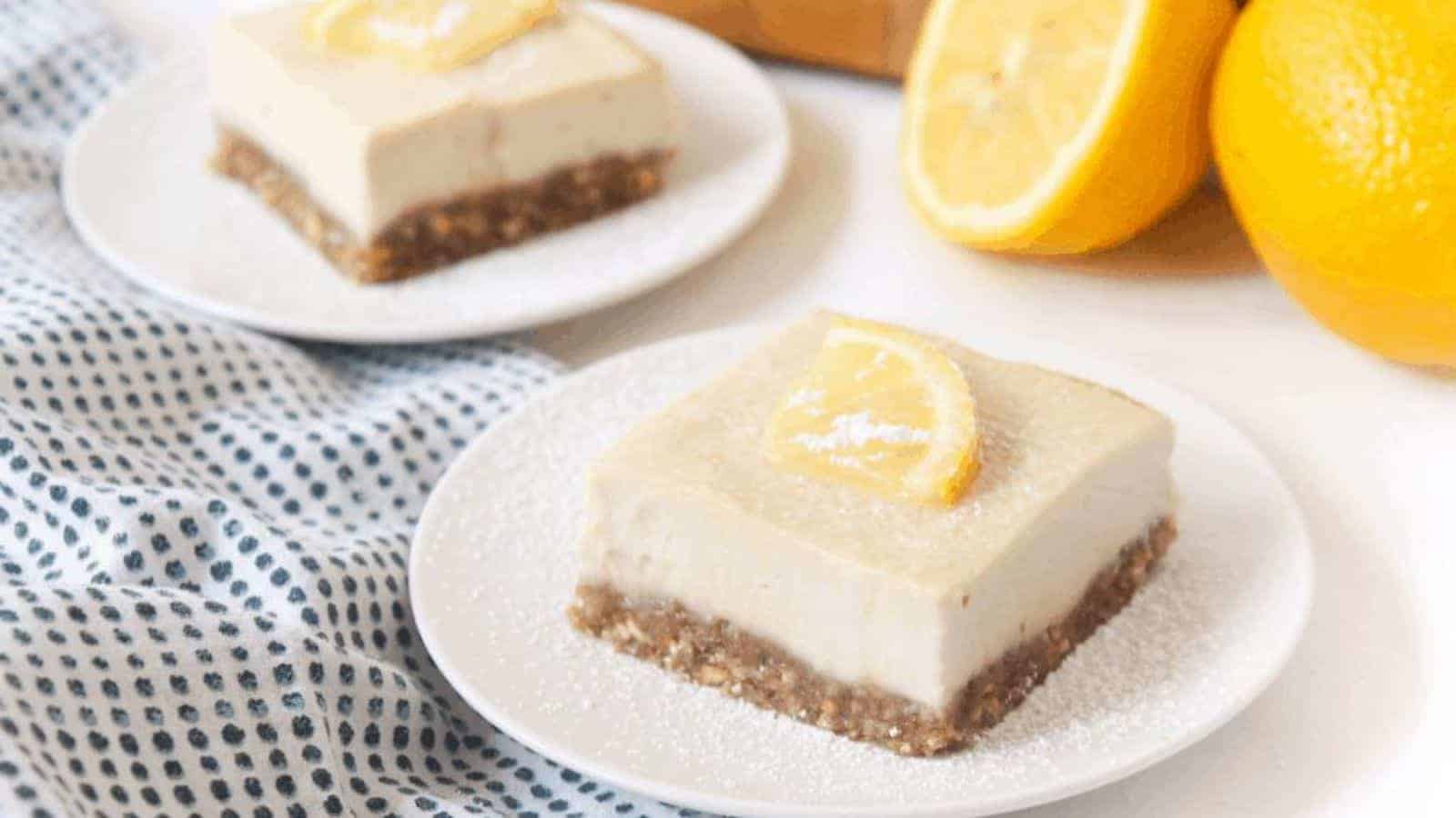 Sliced lemon bars on plates with lemon slices on top.