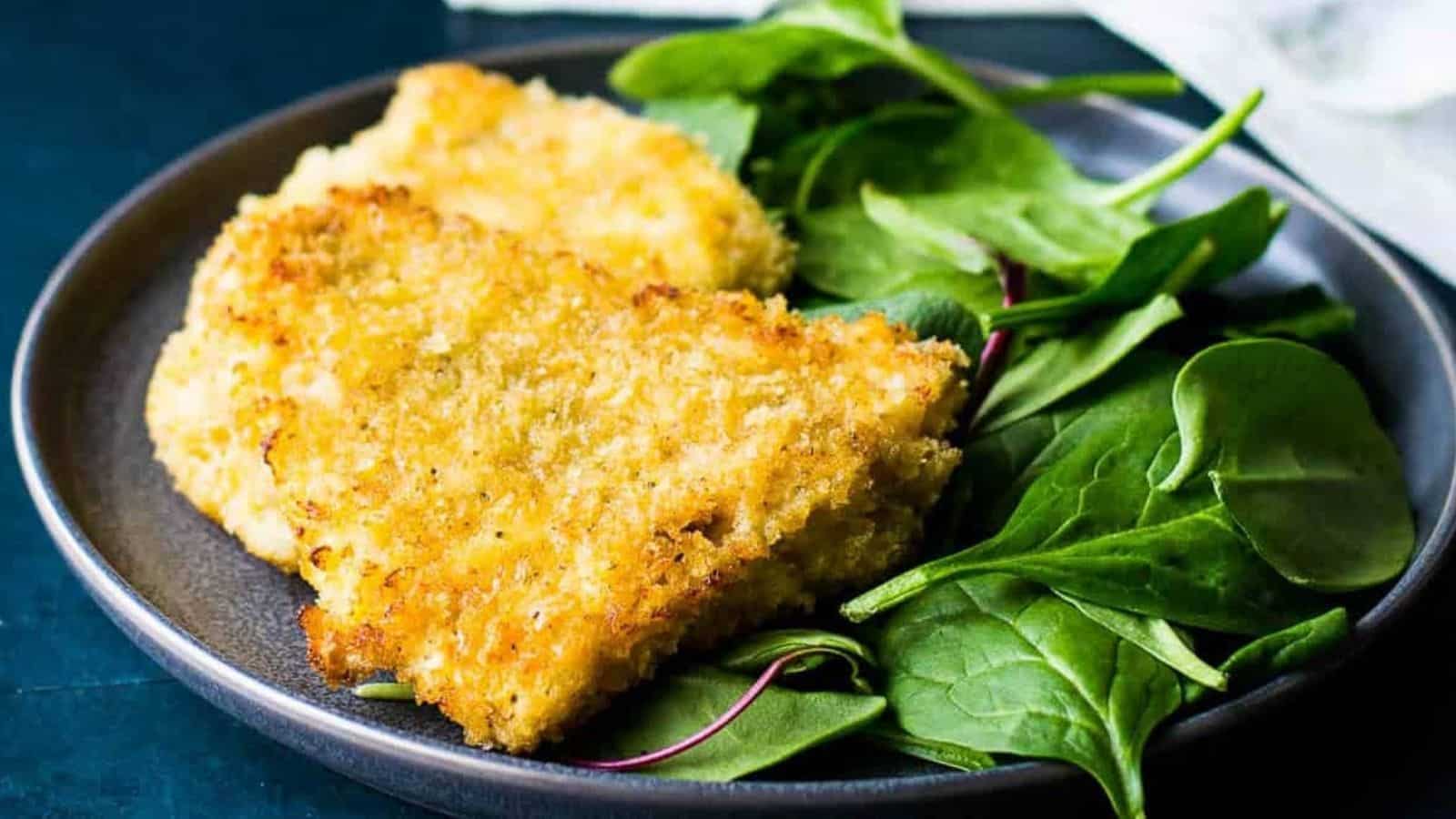 panko crusted rockfish on a plate with spinach.