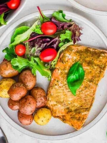 Top view of pesto salmon in a plate.