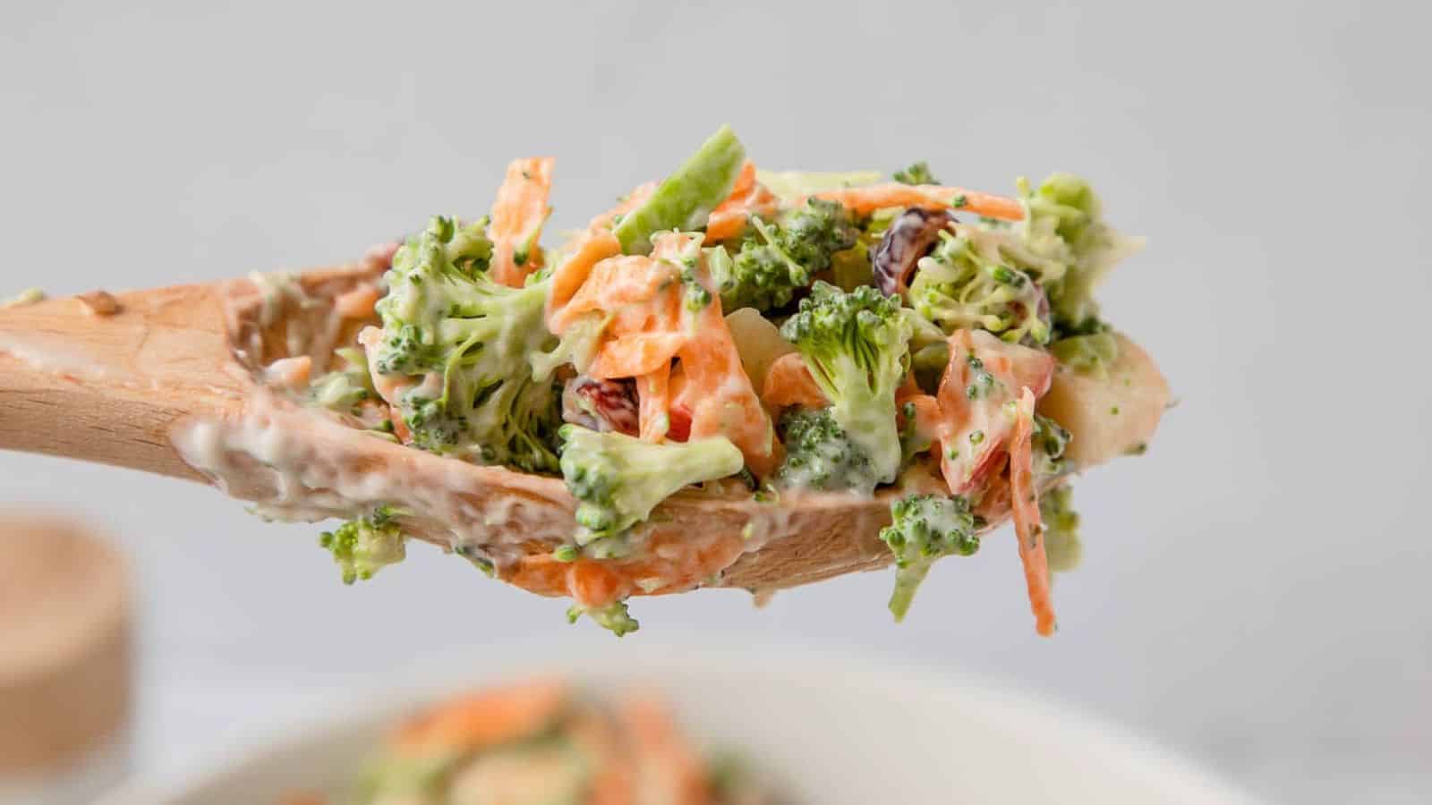 Broccoli and shredded carrots on a mixing spoon.