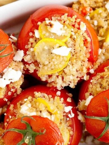 Flatlay of stuffed tomatoes with 'lids' on.