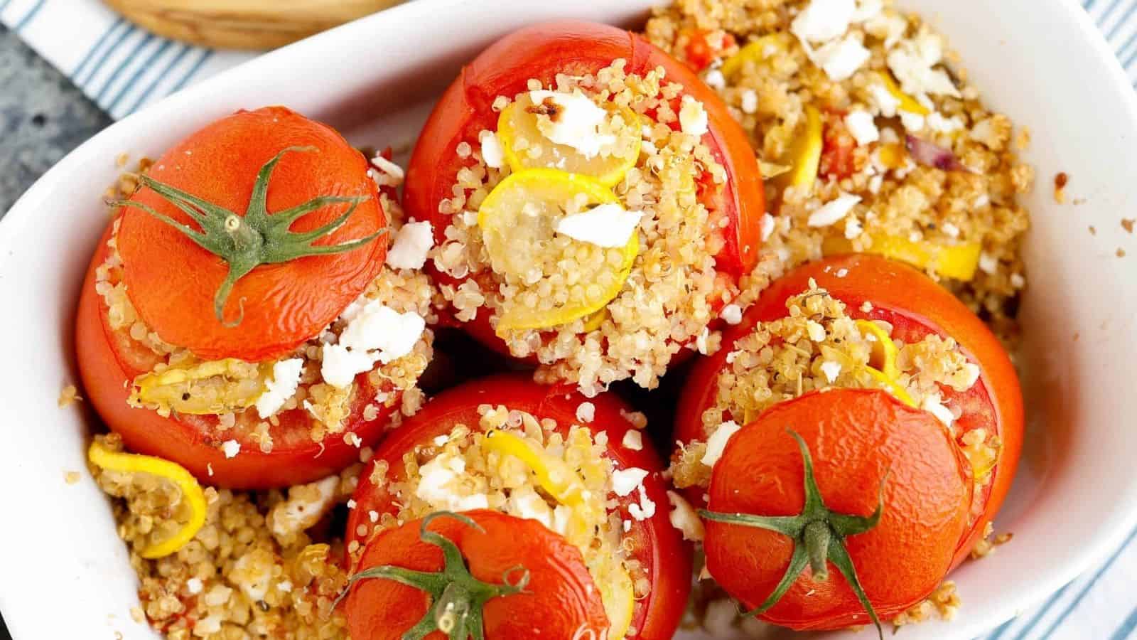 Flatlay of stuffed tomatoes with 'lids' on.