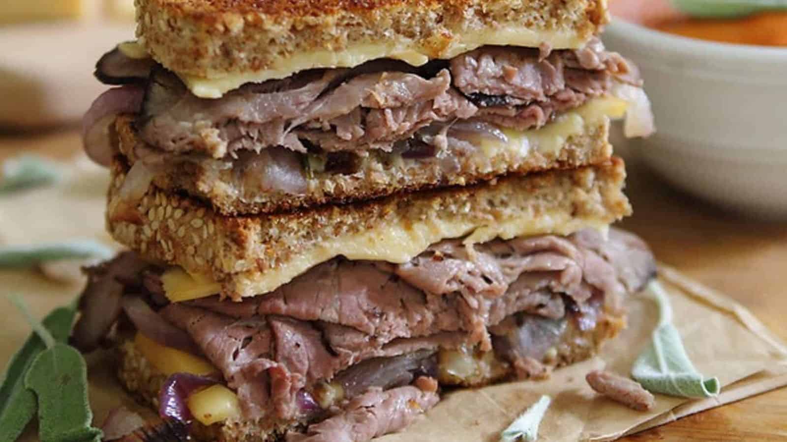 Smoked gouda roast beef grilled cheese cut in half and stacked.