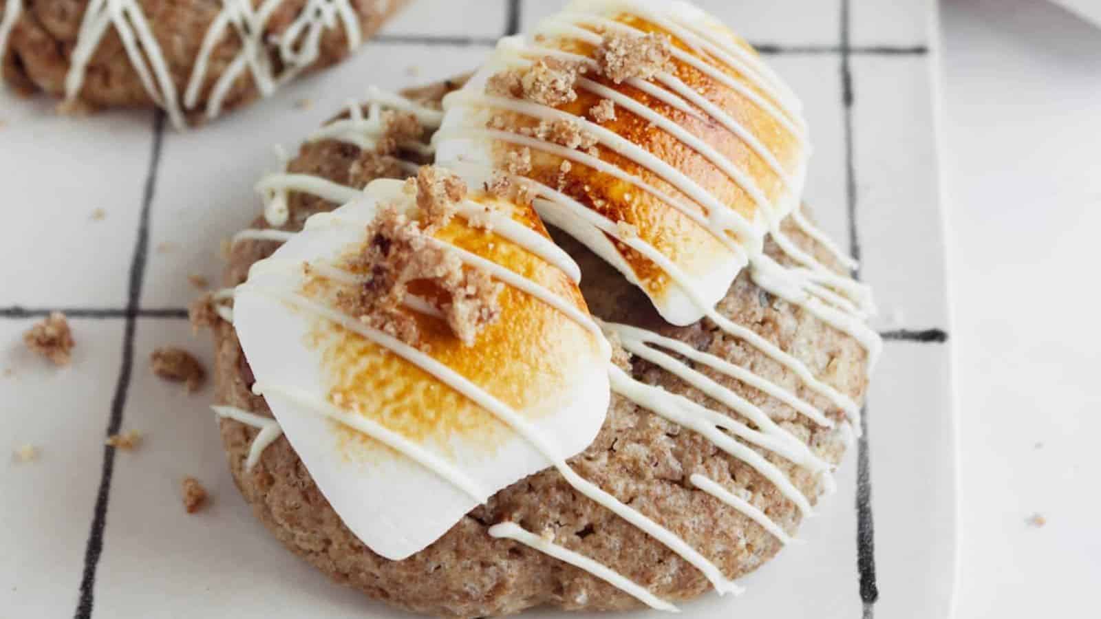 A front view of a s'mores Crumbl cookie with marshmallows and white melted chocolate on top.