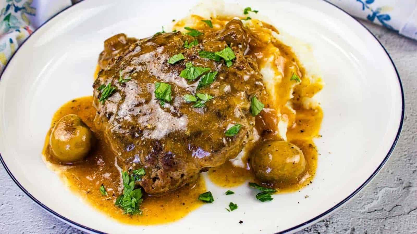 Salisbury Steak on a bed of mashed potatoes.