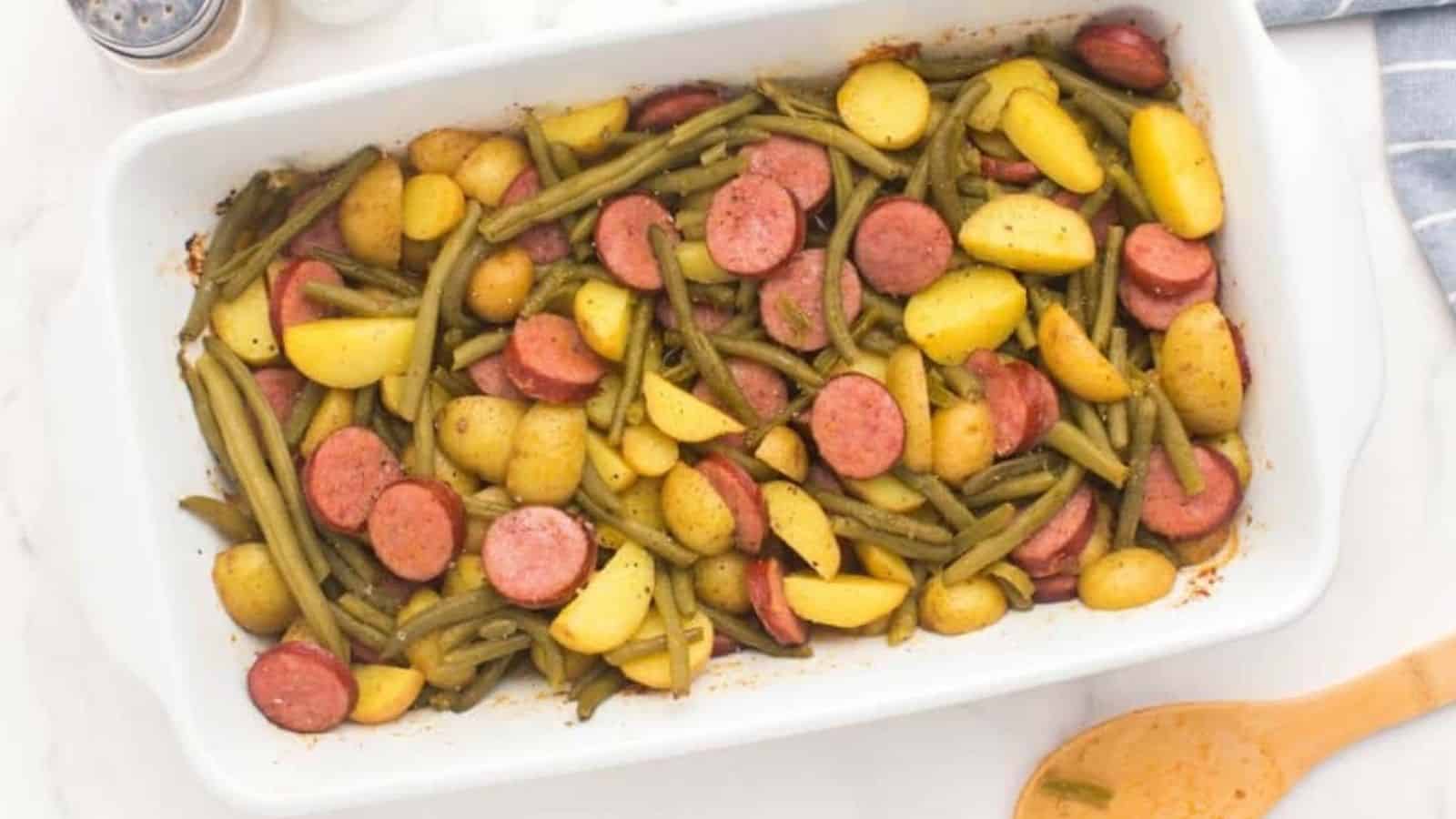 Overhead image of sausage potato green bean casserole in a white plate.