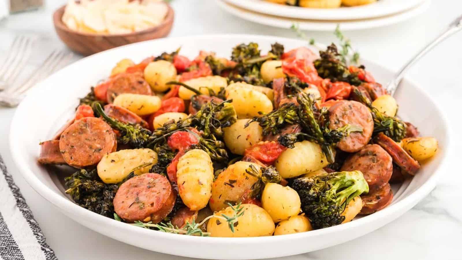 A plate of sheet pan gnocchi and sausage.