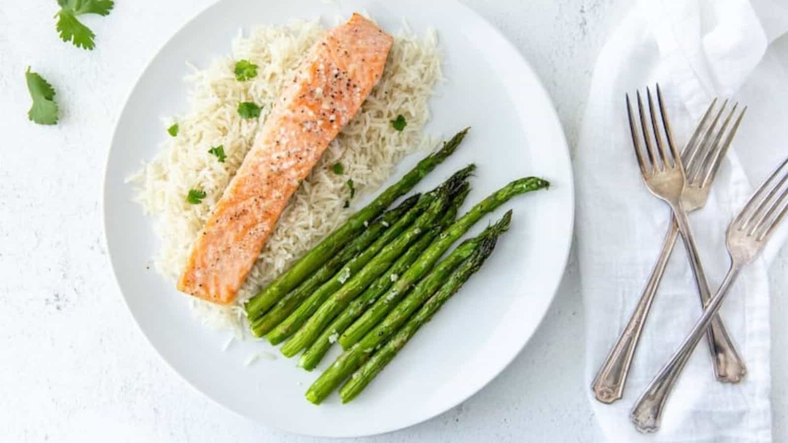 Sheet Pan Salmon Asparagus on a parchment paper lined sheet pan.