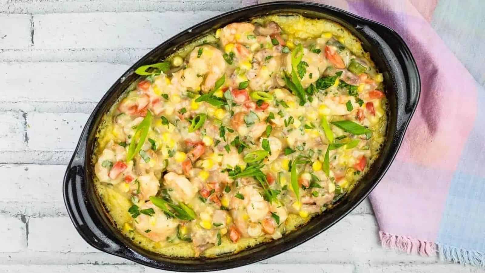 A casserole dish with chicken and vegetables in it.