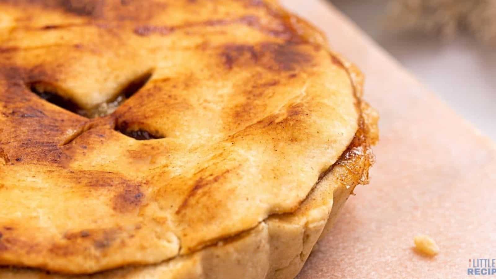 Mini apple pie on cutting board.