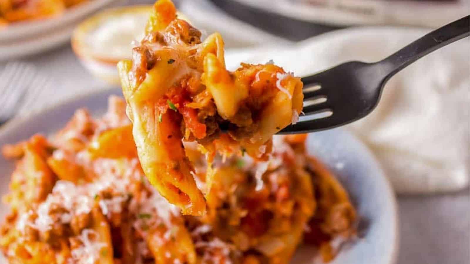 Slow Cooker Cheesy Penne with meat sauce and parmesan cheese.