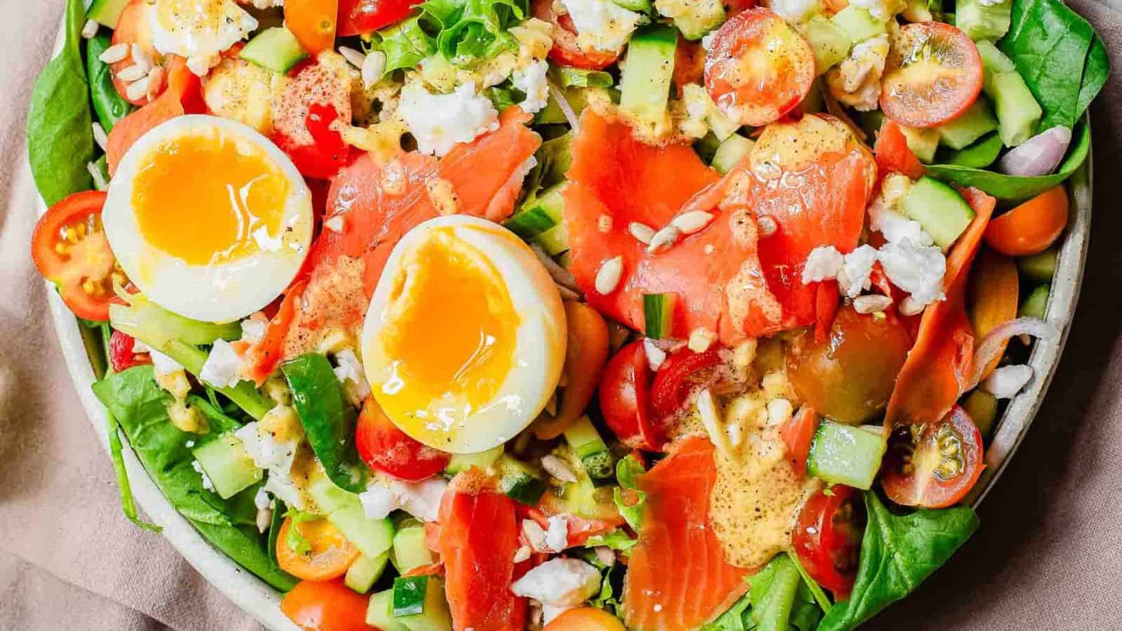 A close-up image of a smoked salmon salad with dijon vinaigrette.