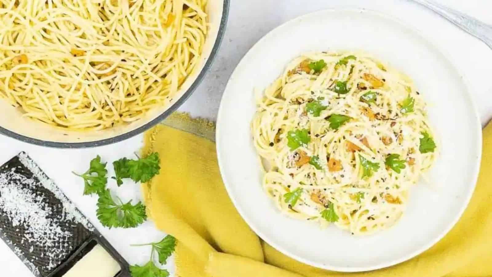 Overhead image of spaghetti aglio e olio with garlic and oil in a white plate.