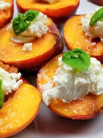 A plate of peaches stuffed with goat cheese and basil.