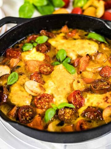 Tomato Mozzarella Baked Chicken inside cast iron.