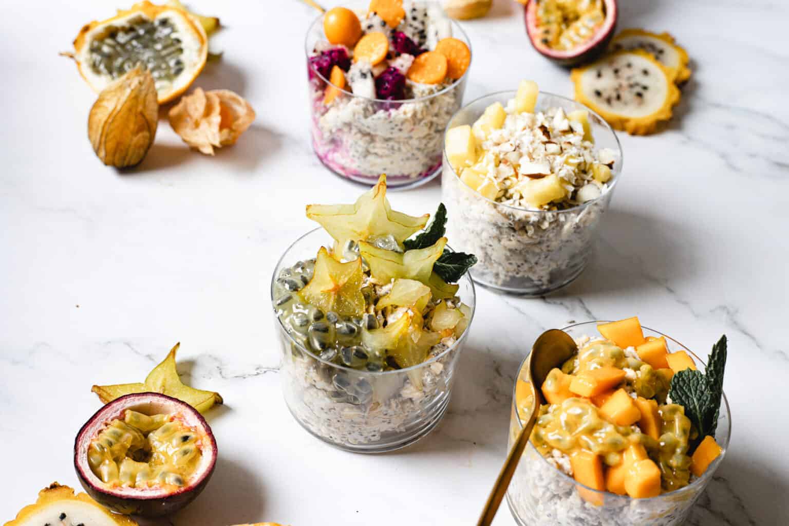 Four combinations of vegan overnight oats with fruit.