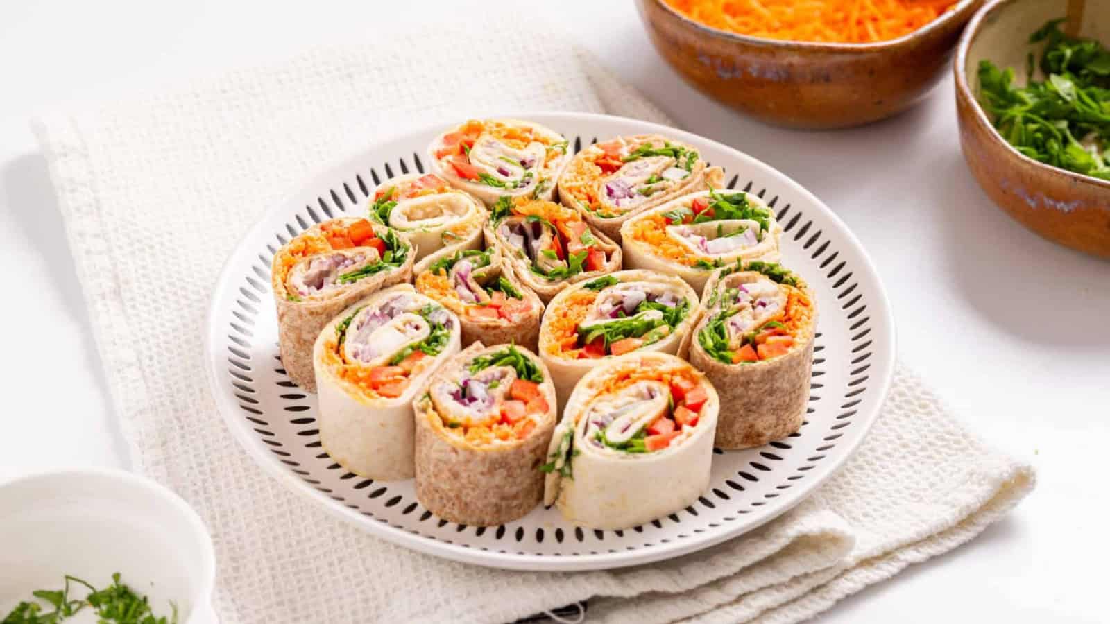 An image of veggie pinwheels on a serving plate.